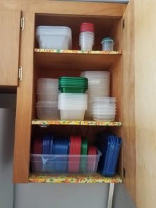 Organized tupperware in a kitchen drawer