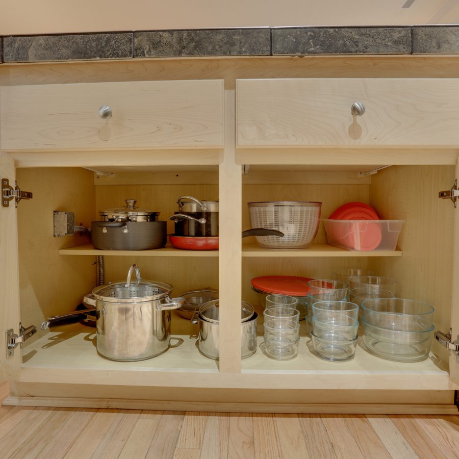 Organized kitchen cabinet with glassware and pots and pans by ReSPACEd Professional Organizing in Portland